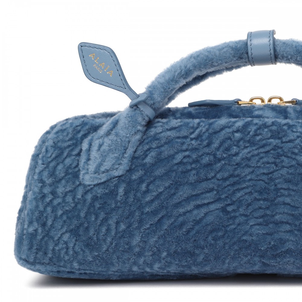 Le Teckel shearling clutch bag